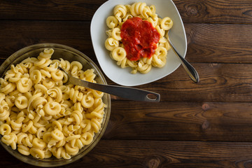 Plate of pasta with tomato sauce next to dish