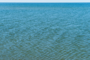 Sea surface. Background ripples on blue water.