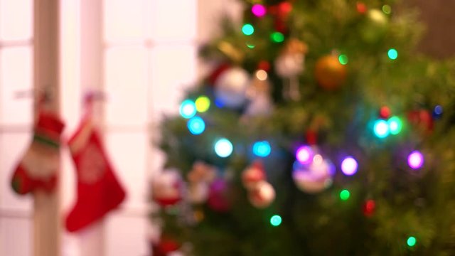 Blurred New Year tree with twinkling lights. Abstract blurred Christmas holiday background. Festive glowing background.