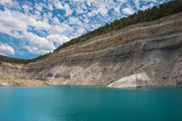 Fototapeta na wymiar Turqoise lake in an open pit mine