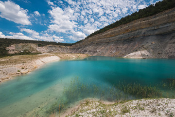 Turqoise lake in an open pit mine
