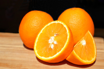 oranges whole and cut on the table