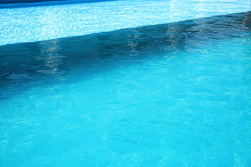 Fototapeta na wymiar Clear refreshing water in swimming pool