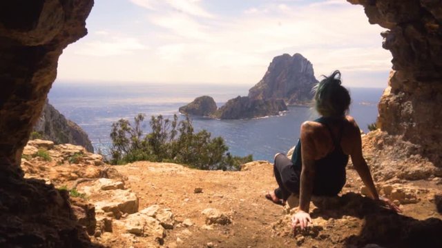 Pirate lookout cave at Ed Vedra in Ibiza, Spain Balearic Islands in Europe. Its looks out to the beautiful sea and landscape of Es Vedra. This Mediterranean coastline is beautiful in the summer.