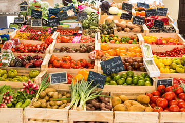 Vegetables and fruits in wooden crates at market
