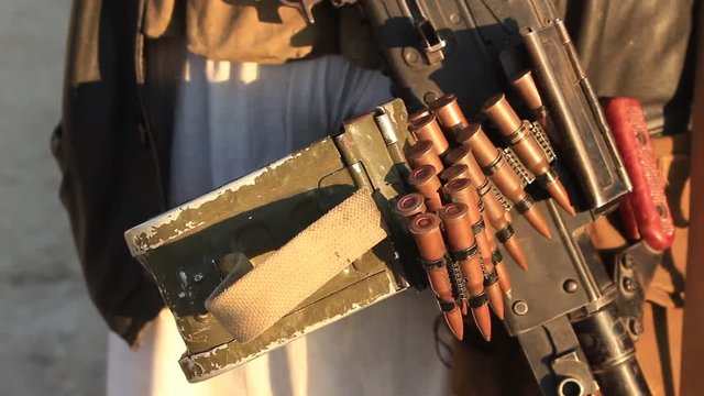 Close up of man holding machine gun