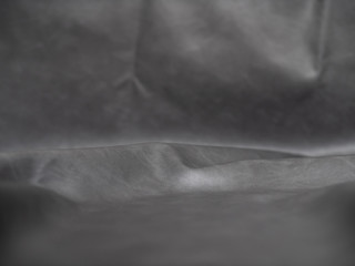 Grey false leather spread out with wrinkles _ ideal for for backround texture and product display