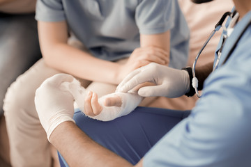 Treat me. Professional medical worker having special instrument and wearing sterile gloves while...