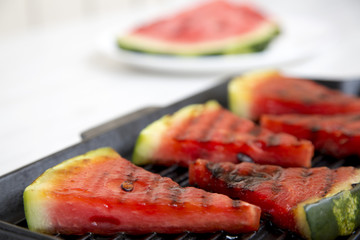 Grilled watermelon in grilling pan, closeup. Selective focus.
