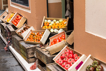 Vegetables and fruits in wooden crates at market