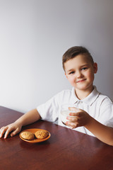 Cookies, milk and a boy in the kitchen.
