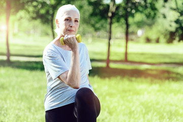 Strong pensioner. Dedicated enthusiastic pensioner doing her regular exercises attentively and...
