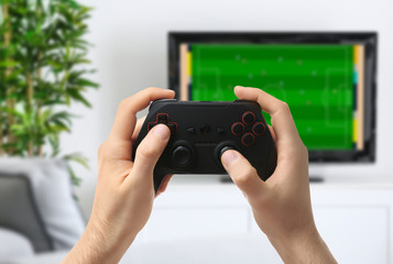Man with controller playing video game at home. Leisure and entertainment