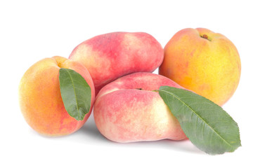 Different varieties of large fresh peaches on a white isolated background