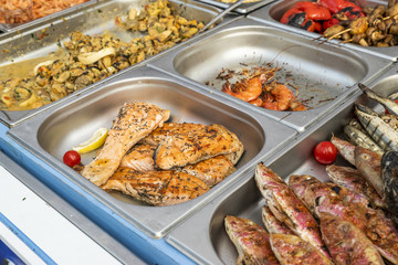 a table with fried fish on the market counter