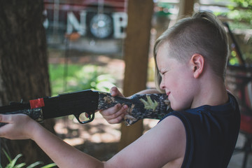 Young Boy Shooting BB Gun