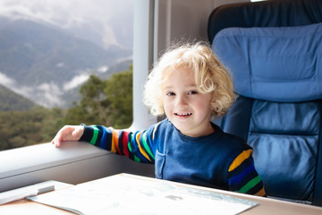 Kids travel by train. Railway trip with child.