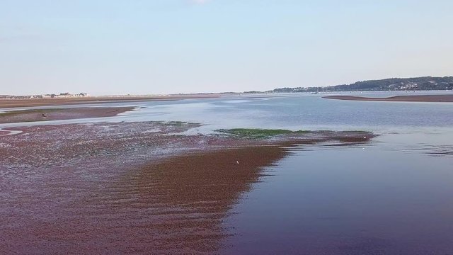 Beautiful drone footage of Lympstone harbour, England. Right movement.