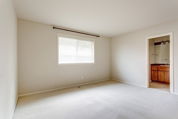 Light beige empty room with carpet floor.