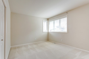 Small empty room with cream walls.