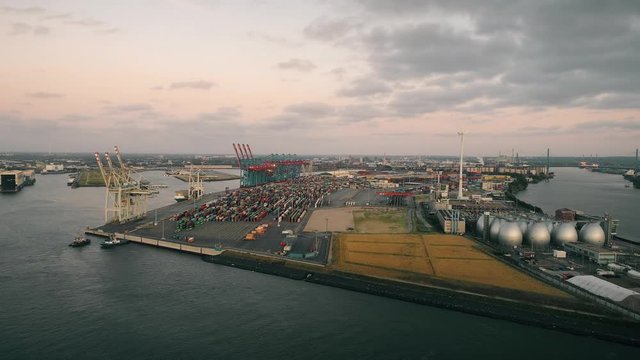 Aerial view of amazing sunset at port of Hamburg, Germany. Boats, ships and beautiful buildings. Industrial area, lots of cargo containers.