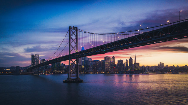 Aerial Cityscape view of San Francisco and the Bay Bridge with Colorful Sunset