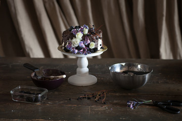 festive chocolate glazed cake decorated with flowers