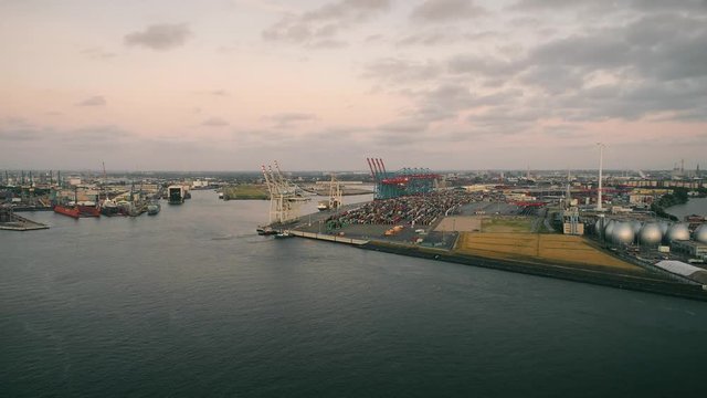 Aerial view of amazing sunset at port of Hamburg, Germany. Boats, ships and beautiful buildings. Industrial area, lots of cargo containers.