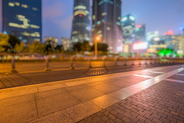 night view of empty brick floor front of modern building
