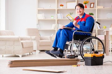 Disabled man laying floor laminate in office