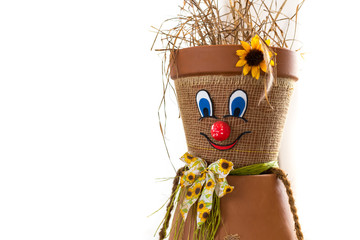Puppet made of flowerpots and straw sitting on a board
