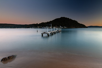 Sunset waterscape and old wharf