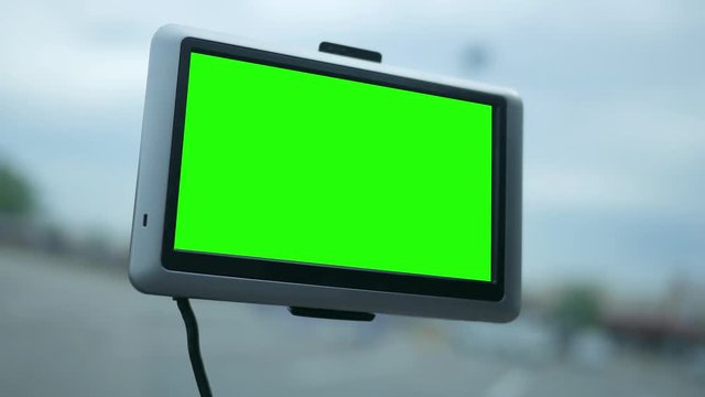 Modern GPS screen in a car dashboard with green screen for corner pin shots