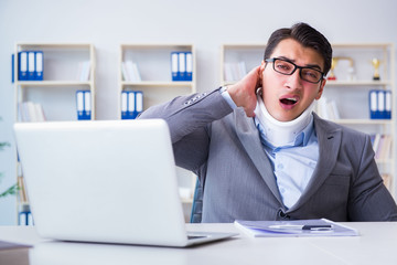 Businessman with neck injury working in the office