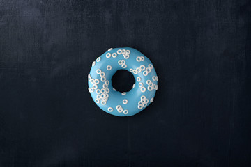 Top view blue donut  on black wooden table . 3d rendering .