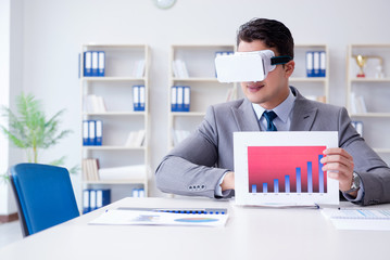 Businessman with virtual reality glasses in the office