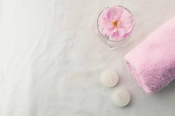 Obraz na płótnie Canvas Pink Rose Flower in Soft Color, sSpa and Beauty Concept white tissue Background Copy space, salt for bath, pink pastel towel