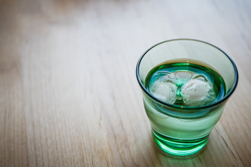 Water in modern glass with cube ice.