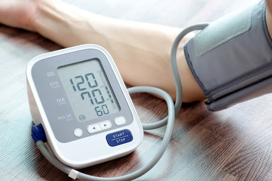 Man check blood pressure monitor and heart rate monitor with digital pressure gauge. Health care and  Medical concept