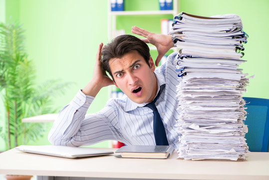 Businessman having problems with paperwork and workload