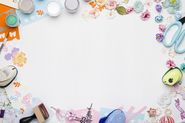 Empty white space in the center surrounded by paper flowers, multi-colored paper and scrapbooking...
