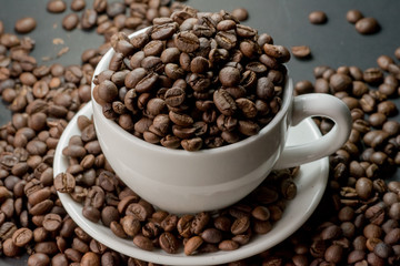 coffee in cup and coffee beans are the background.