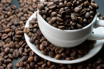 coffee in cup and coffee beans are the background.