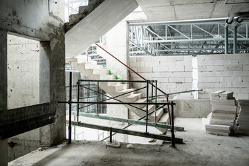 building site under construction with cement wall and steel  frame constructure