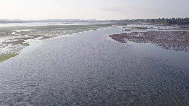 Day time flying over the coastal town of Lympstone in East Devon in South West England. The beach is in the background. Discover nature from the sky.