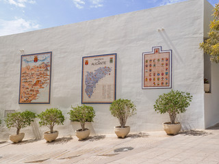 mosaic on a white wall with the coats of arms of the municipalities and the map of the province of...