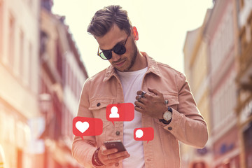 Young Adult man holding smartphone in hand with Like, follower, comment counter