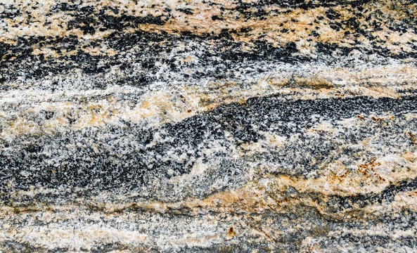 background texture-close up of black, gray, white and orange patterns in volcanic rock from Montana