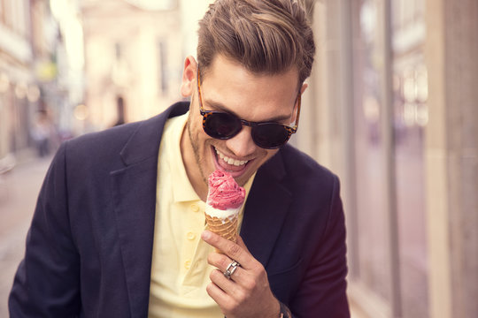 Young Adult Man Eat Ice Cream On The Street