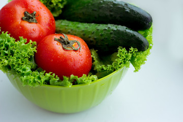 Fresh red tomatoes, green salad and cucumber